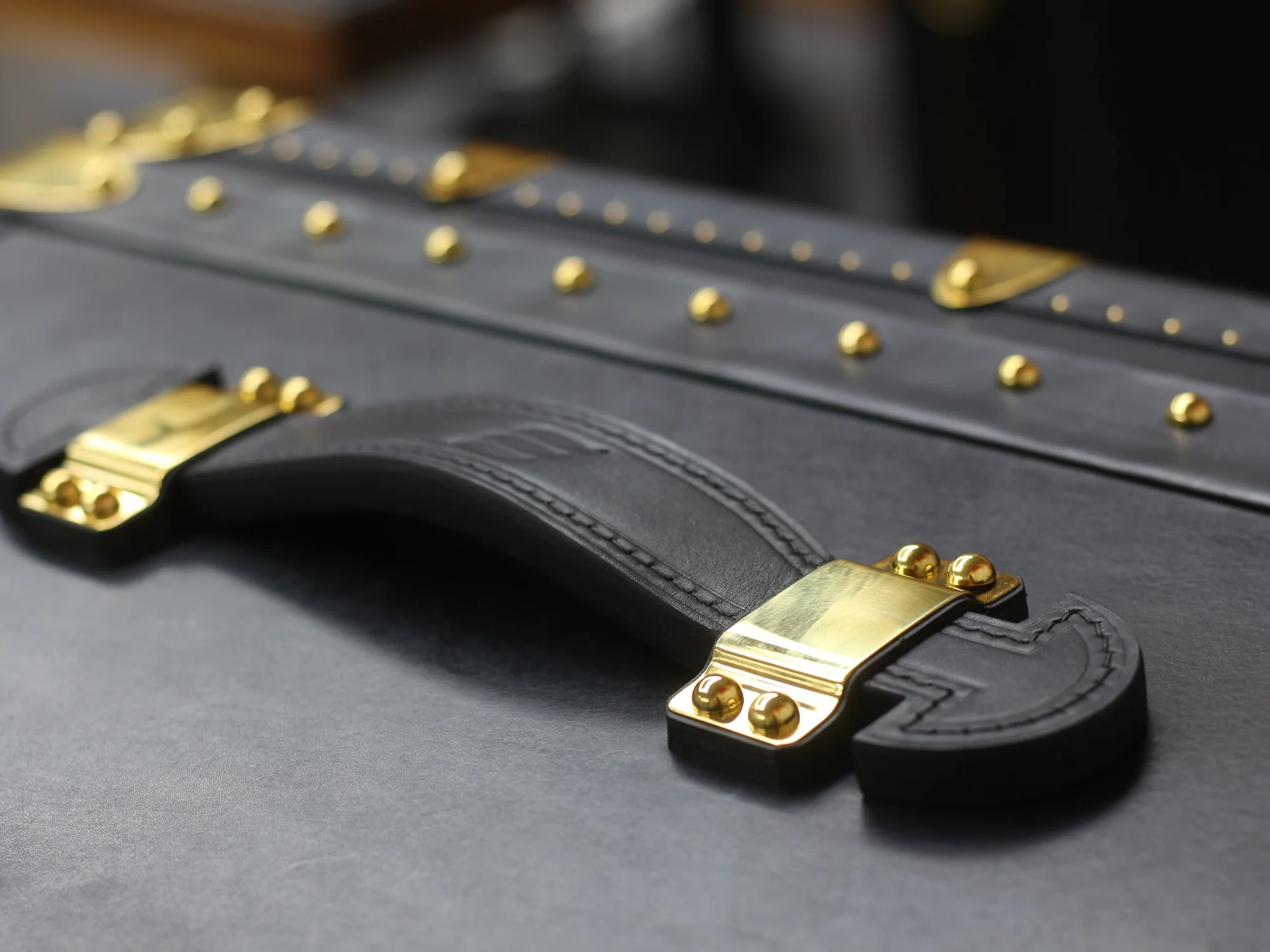 Black Collector's Trunk, hand-stitched leather handle detail