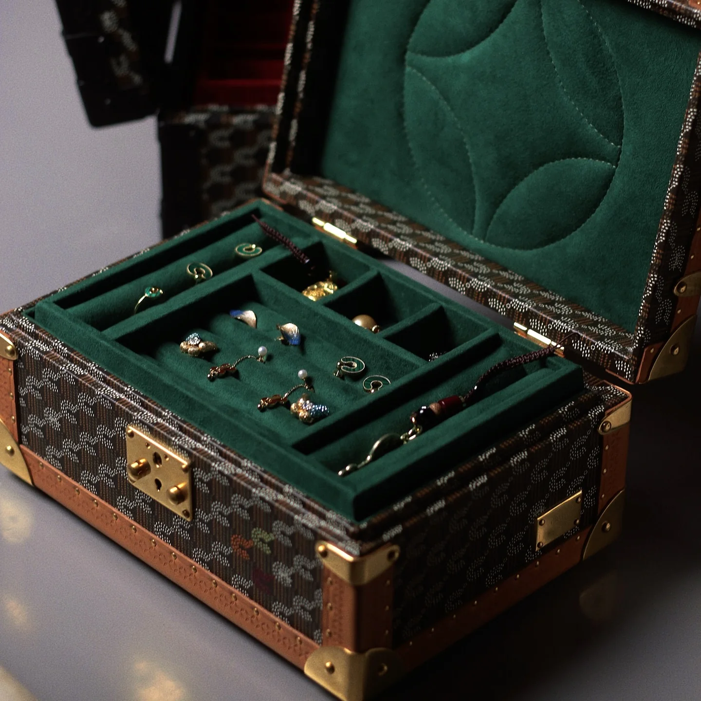 Open patterned jewelry case with a green fitted interior