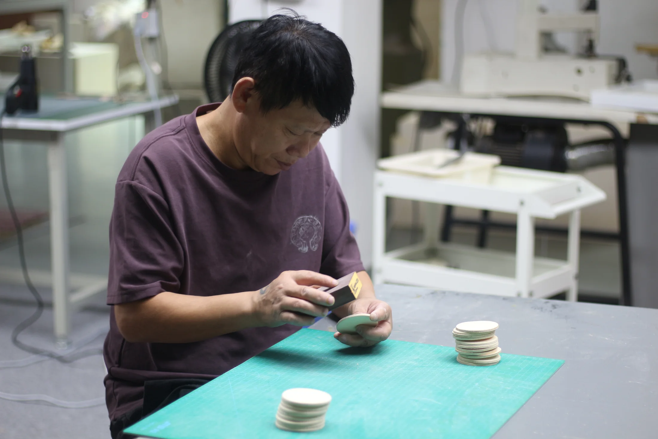 A Pusu Atelier maker preparing a component at the workbench
