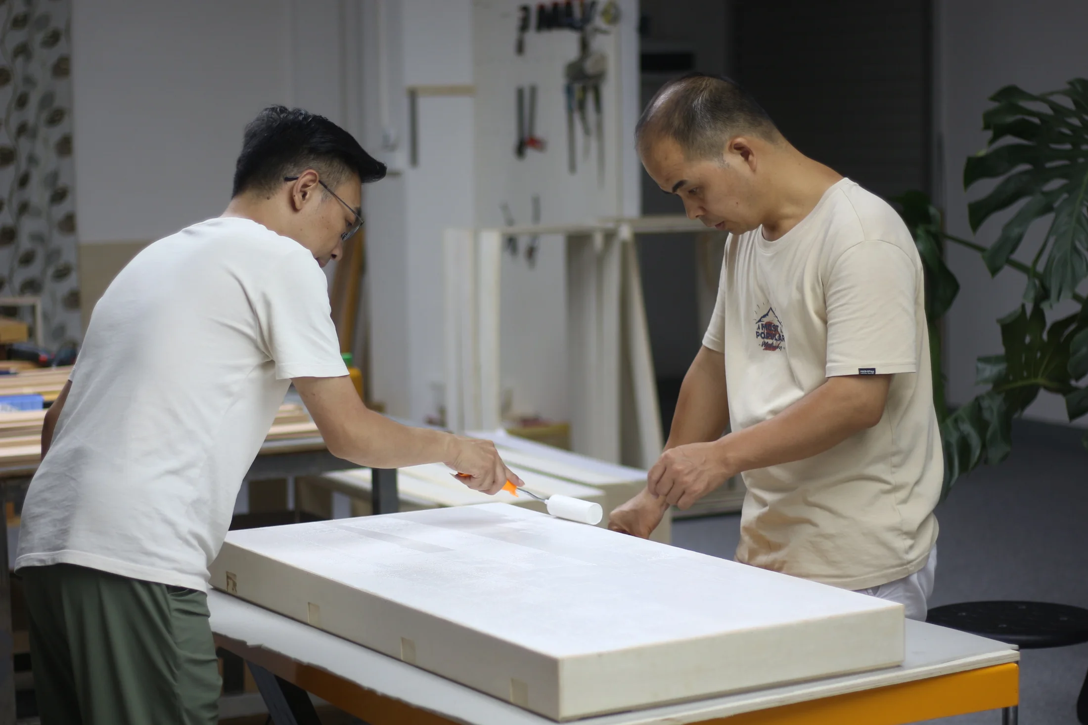 Two Pusu Atelier makers preparing a case structure together at a worktable