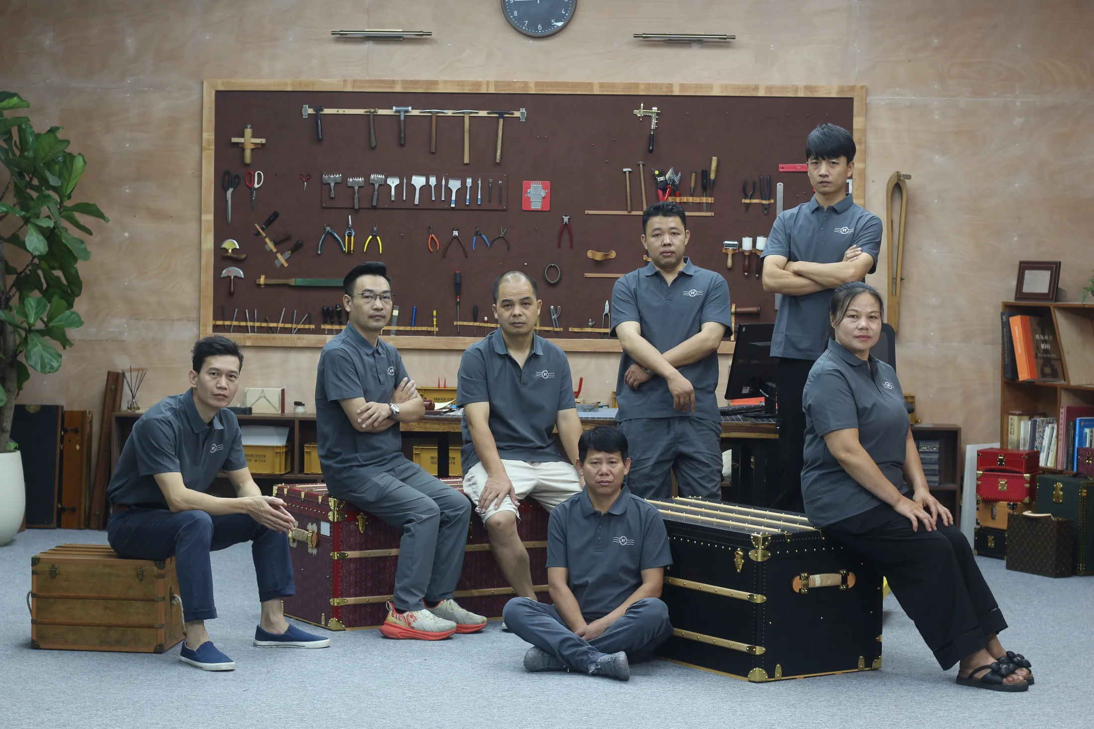 The Pusu Atelier team with tools and finished cases in their Guangzhou workshop