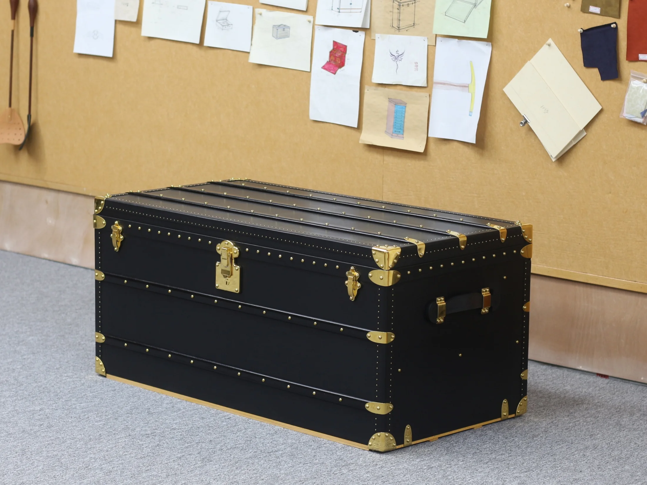Black handcrafted trunk with gold-tone fittings