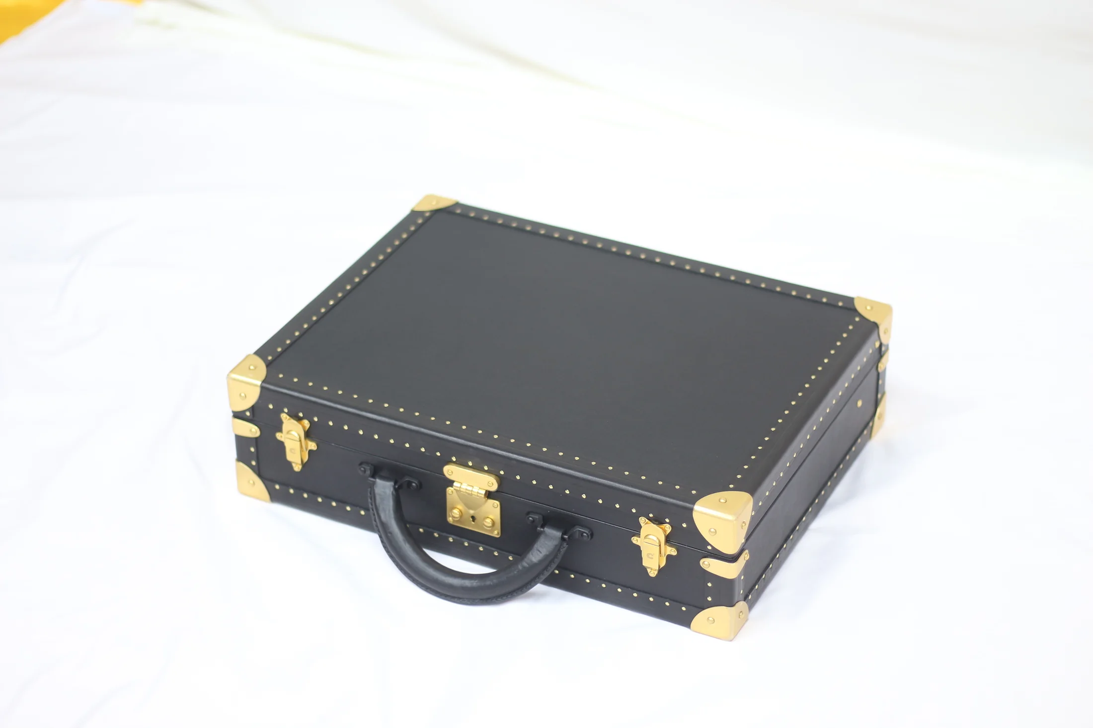 Open black watch case with a watch displayed inside