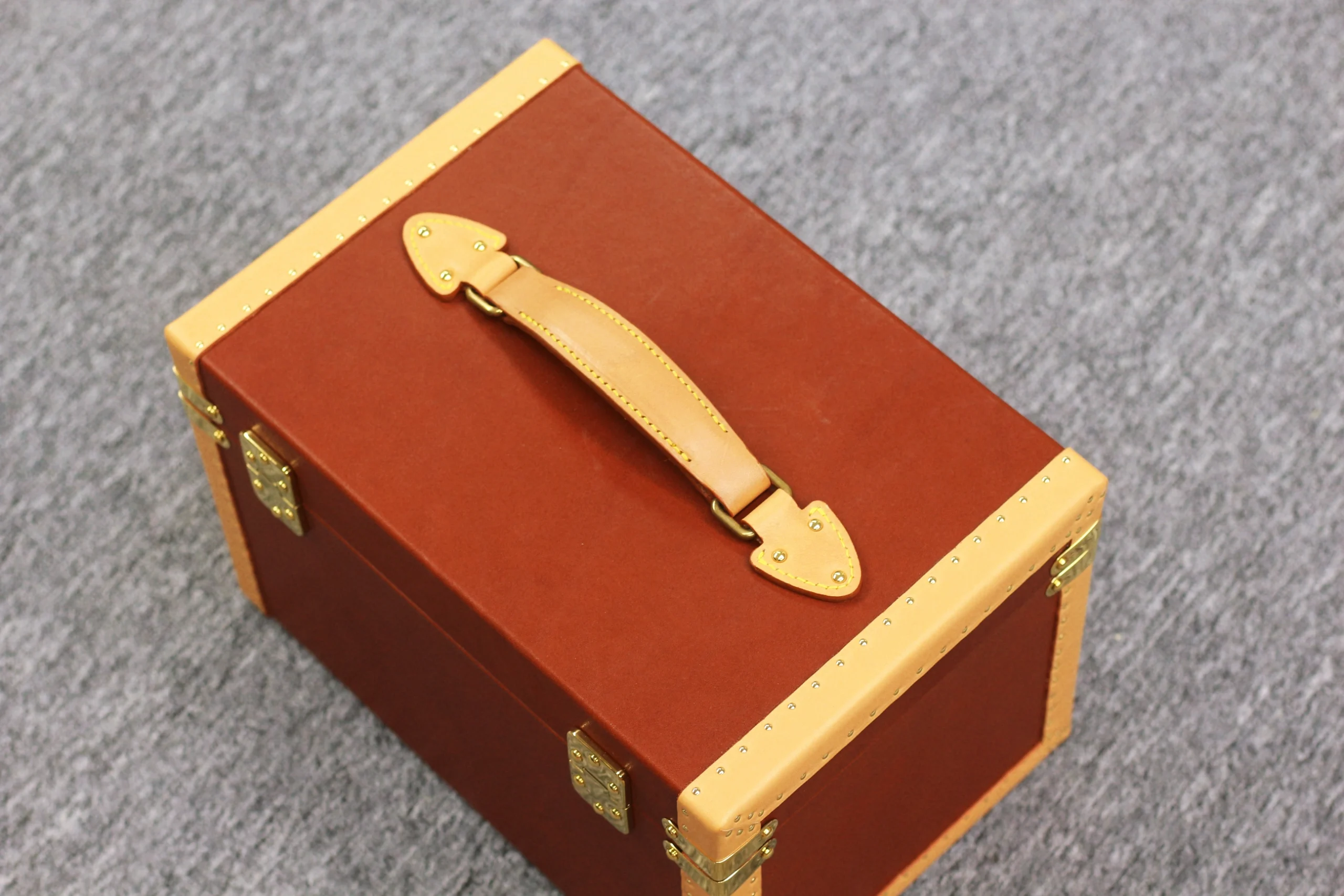 Solid brass corner guard and rivets detail on leather case
